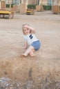 Boy with blond hair have fun on sand Royalty Free Stock Photo