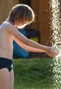 Boy with Blond Hair at Outdoor Shower Royalty Free Stock Photo