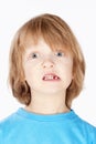 Boy with Blond Hair Showing his Missing Milk Teeth Royalty Free Stock Photo