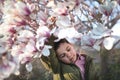 Boy and blooming magnolia.