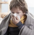 Boy blow her nose and get cold at home. Children illness