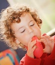 A boy blowing balloon Royalty Free Stock Photo