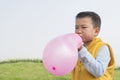 Boy blowing balloon