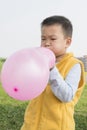 Boy blowing balloon Royalty Free Stock Photo