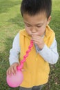 Boy blowing balloon Royalty Free Stock Photo