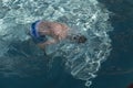 Boy blowing bubbles underwater in swimming pool Royalty Free Stock Photo