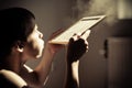 Boy blowing dust from chalk board