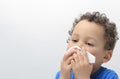 Boy blowing nose after catching a cold stock photo Royalty Free Stock Photo