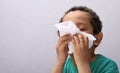 Boy blowing nose after catching a cold stock photo Royalty Free Stock Photo