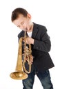 Boy blowing into a trumpet against white background Royalty Free Stock Photo