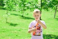 The boy blows bubbles in the park. Royalty Free Stock Photo