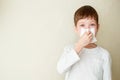 Boy blows his nose on a white background Royalty Free Stock Photo