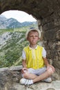 boy in a blue hat sitting in the observation window of the ancie