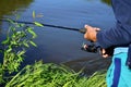 Boy with spinning in his hands fishes on a summer day by the river Royalty Free Stock Photo