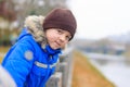 Boy in blue jacket leans on the railing of the fence Royalty Free Stock Photo