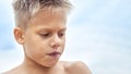 Boy with blue lips frozen from swimming in cold sea water Royalty Free Stock Photo