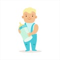 Boy In Blue Pants Standing With Milk Bottle, Adorable Smiling Baby Cartoon Character Every Day Situation Royalty Free Stock Photo