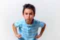 A boy in a blue T-shirt blew his cheeks and clenched his fists Royalty Free Stock Photo