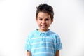 A boy in a blue T-shirt depicts a disgruntled grimace Royalty Free Stock Photo