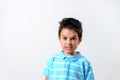 A boy in a blue T-shirt depicts a disgruntled grimace Royalty Free Stock Photo