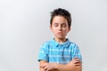 The boy in the blue T-shirt folded his hands on the slude and closed his eyes Royalty Free Stock Photo