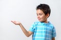 A boy in a blue T-shirt holds an open palm in front of him Royalty Free Stock Photo