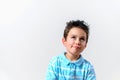 A boy in a blue T-shirt twisted his face and looked up Royalty Free Stock Photo