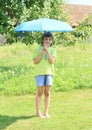 Boy with blue umbrella Royalty Free Stock Photo