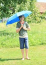 Boy with blue umbrella Royalty Free Stock Photo