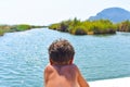 boy on the boat, advancing in the river