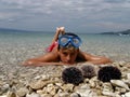 Boy, boat and sea urchins Royalty Free Stock Photo