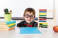 Boy with books and abacus in classroom Royalty Free Stock Photo