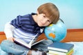 Boy with books and globe Royalty Free Stock Photo