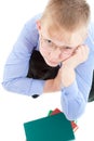 Boy with books look up and prop his head by hand Royalty Free Stock Photo