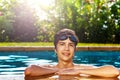 Boy on the border of swimming pool with googles