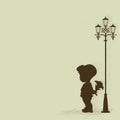 Boy with a bouquet of standing under a street lamp Royalty Free Stock Photo