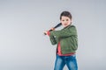 Boy brandishing baseball bat standing