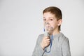 Boy breathing through inhalator mask