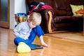 Boy with broken leg in cast playing on tablet. Royalty Free Stock Photo