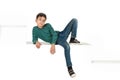 The boy brunette wearing in jeans and shirt in green strip sits