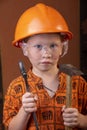 Boy in builder`s clothes