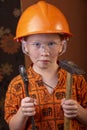 Boy in builder`s clothes