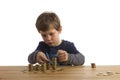 Boy building towers out of money