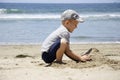 Boy builds a sand castle on the shore Royalty Free Stock Photo