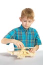 A boy builds a wooden helicopter