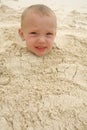 Boy buried in the sand Royalty Free Stock Photo