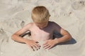 Boy buries itself in the sand Royalty Free Stock Photo