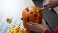 Boy busy carving a pumpkin jack-o-lantern for Halloween - removing the seeds Royalty Free Stock Photo