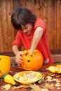 Boy busy carving a pumpkin jack-o-lantern for Halloween Royalty Free Stock Photo