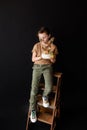 a boy with a cake, he has a birthday, a boy wearing a beige t-shirt and green pants Royalty Free Stock Photo